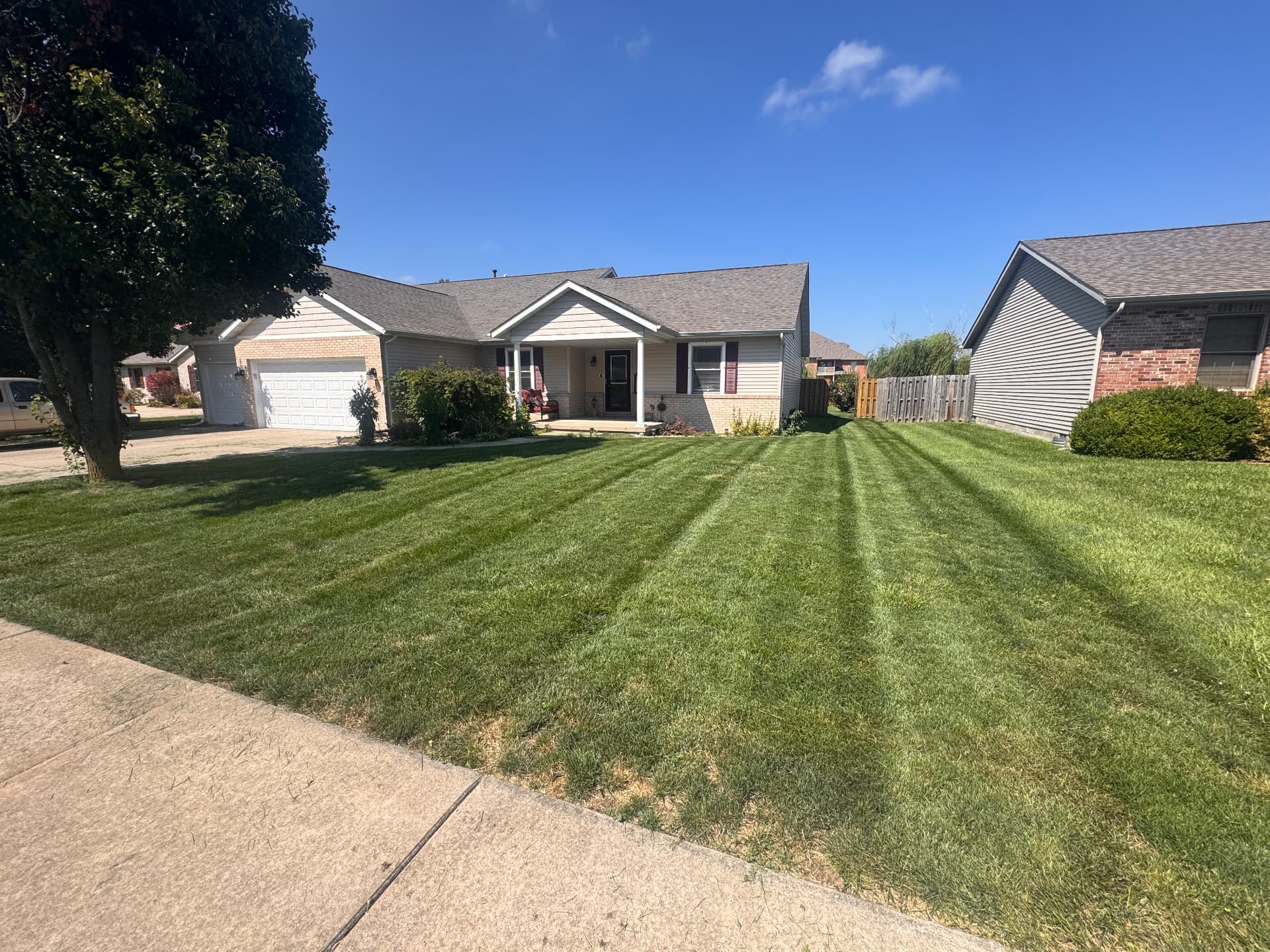 Front lawn finished with crisp diagonal mowing stripes
